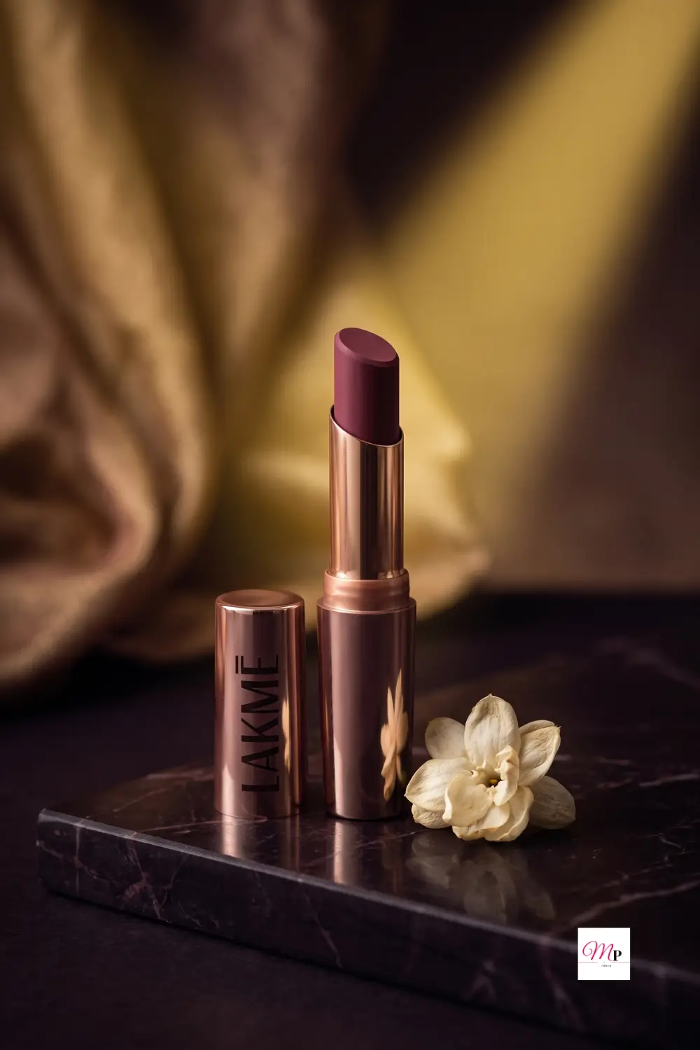 Lakme 9to5 Primer Matte lipstick on vanity with mogra flowers, long lasting matte lipstick India