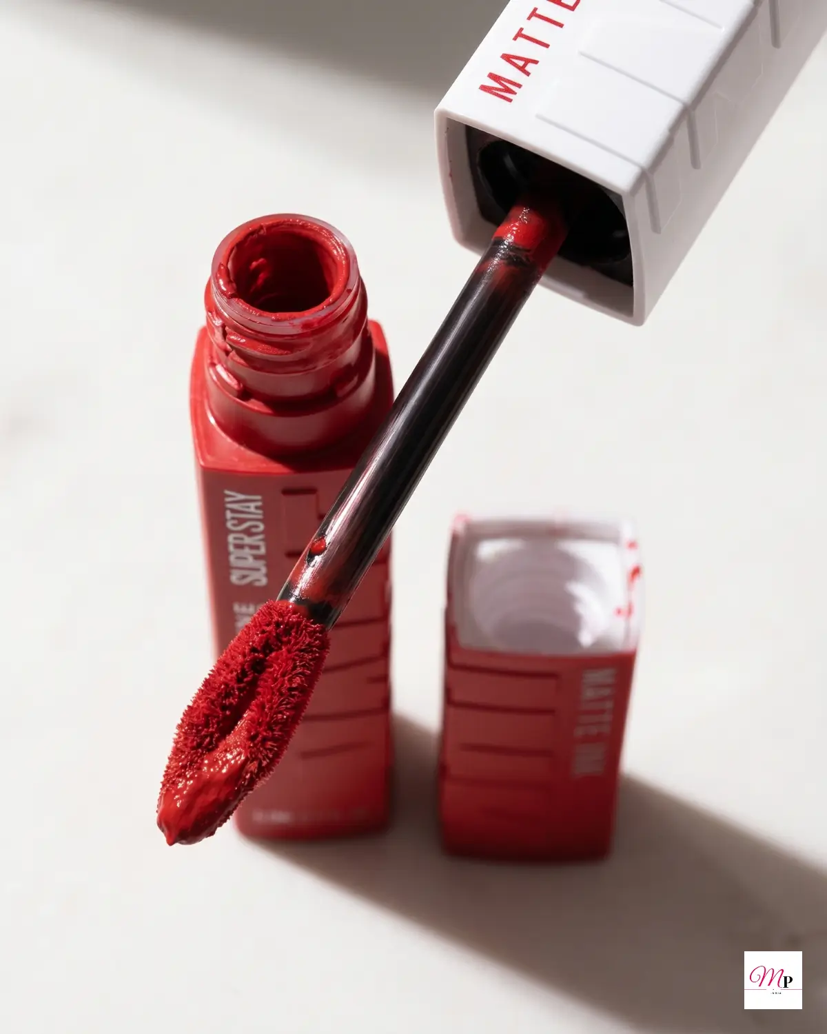 Maybelline SuperStay Enchanter 380 arrow applicator wand close-up showing liquid matte texture