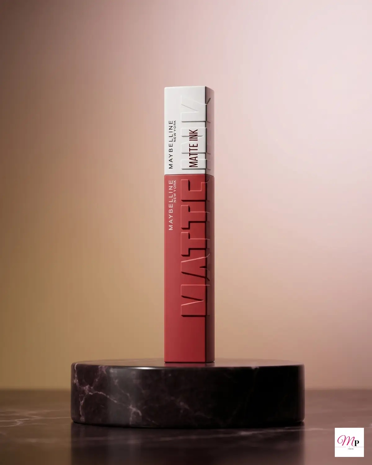 Maybelline SuperStay Enchanter 380 transfer-proof lipstick on black marble pedestal