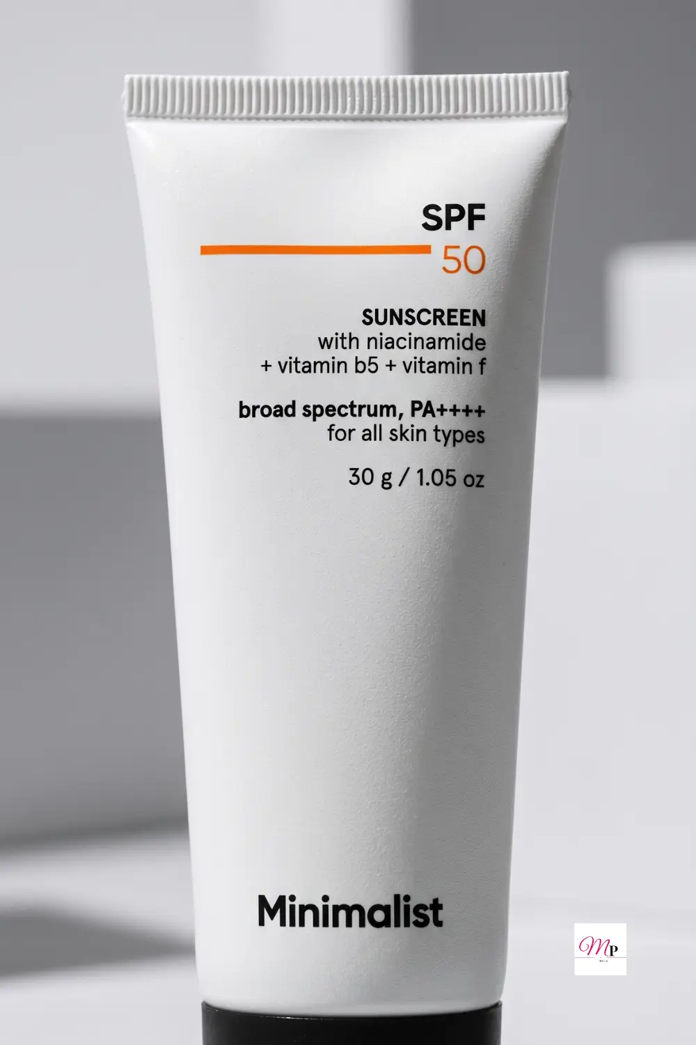 Minimalist SPF 50 sunscreen tube label closeup showing niacinamide vitamin b5 vitamin f broad spectrum PA++++ ingredients