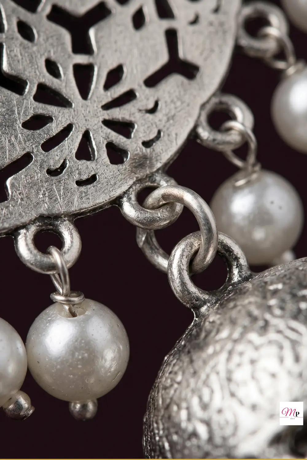Artistic high-contrast silhouette study of oxidised dome jhumka with pearl accents — temple jewellery style earrings India