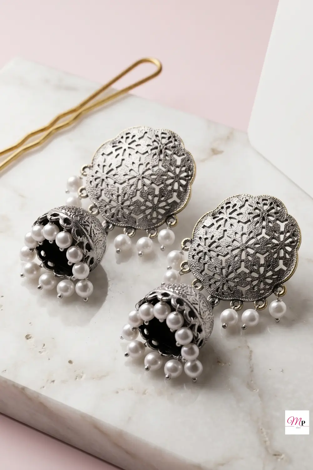 Close-up of single oxidised dome jhumka showing intricate floral cutwork and pearl dangle details — dome shaped jhumkas India