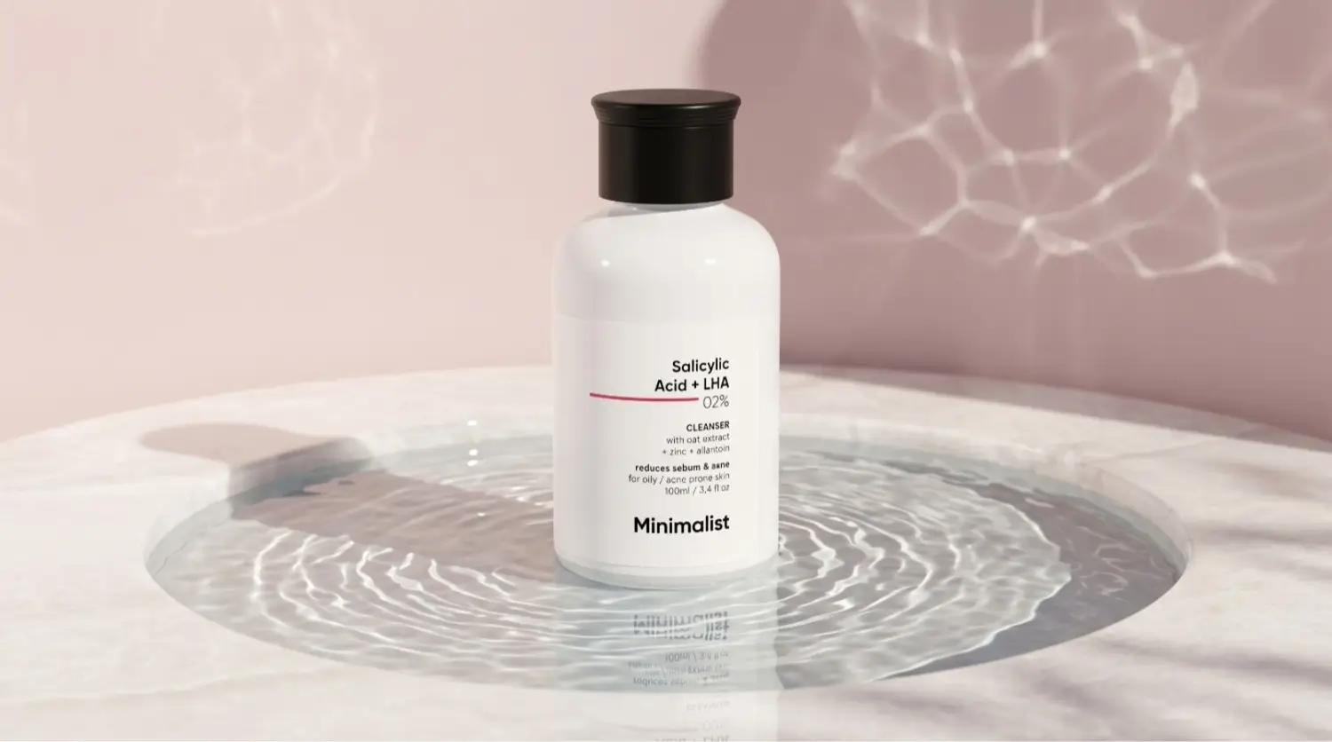 Minimalist 2% Salicylic Acid LHA Cleanser bottle standing in water ripples, salicylic acid face wash oily skin india