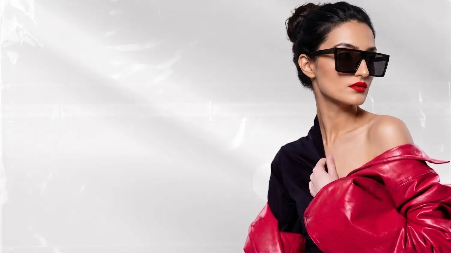Bold sunglasses, red lipstick and leather jacket
