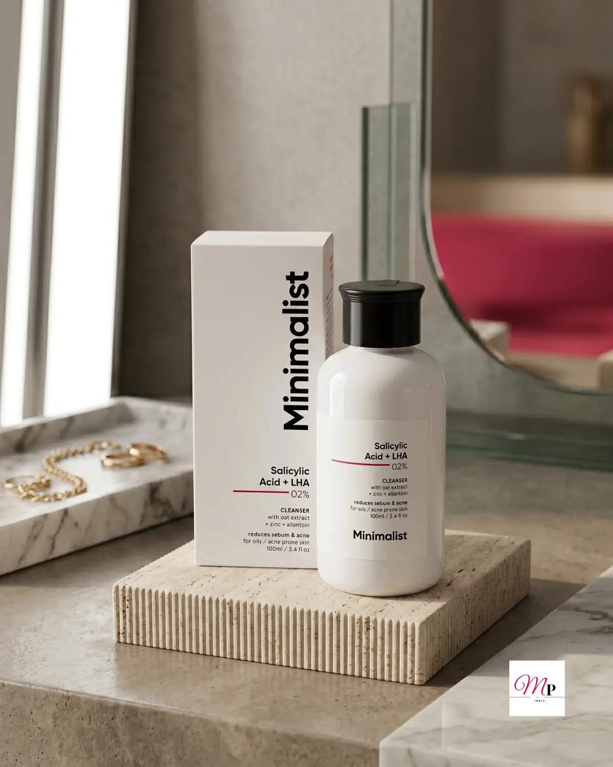 Minimalist BHA cleanser on travertine vanity stand with gold jewelry, luxury bathroom skincare display