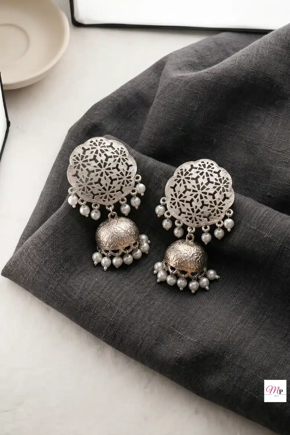 Zaveri Pearls oxidised dome jhumkas with pearl dangles displayed on white marble surface — oxidised dome jhumkas under 500 India