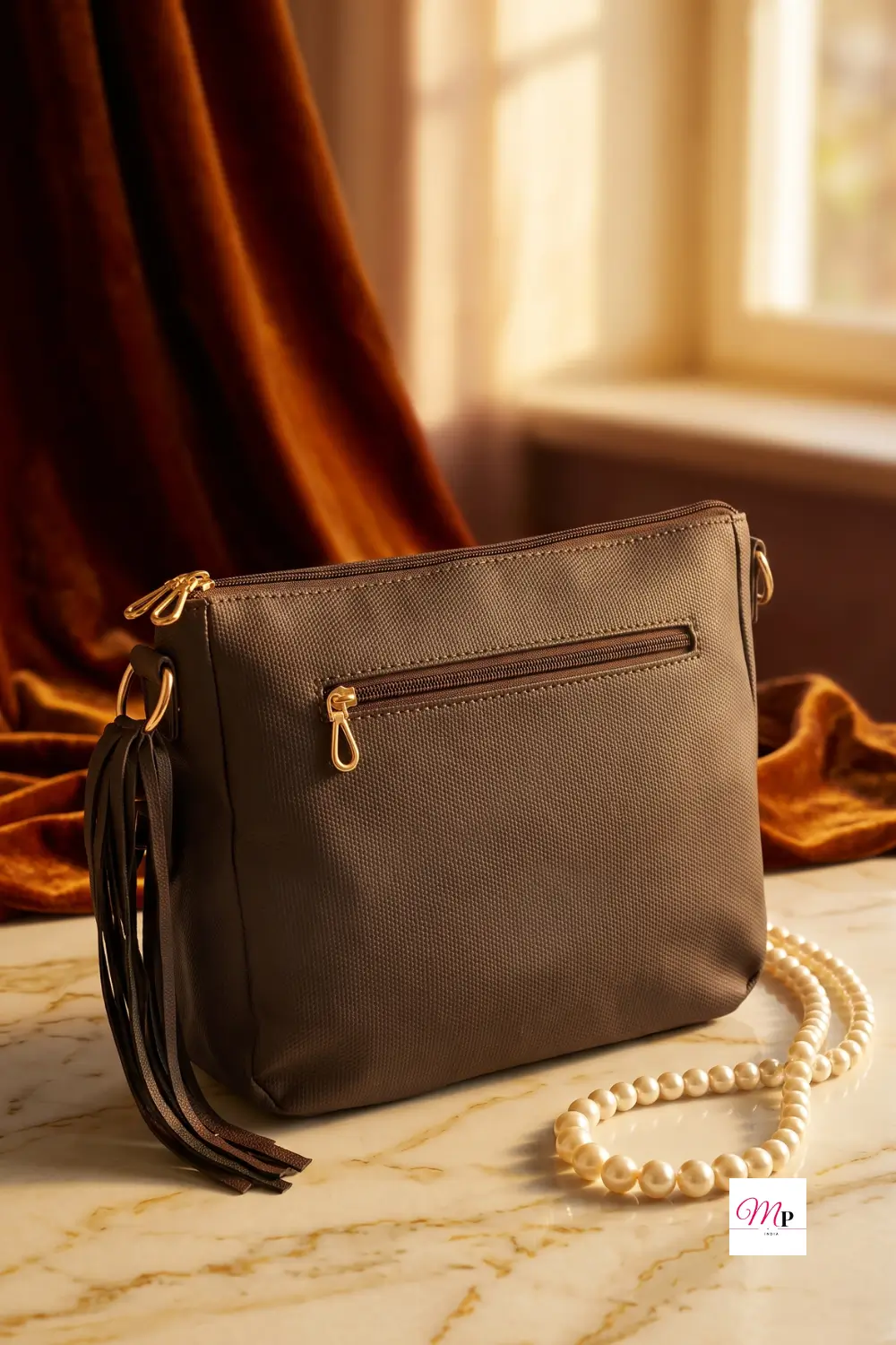 Baggit vegan leather bag back view showing external zip pocket on marble with pearls — luxury accessory flatlay for women