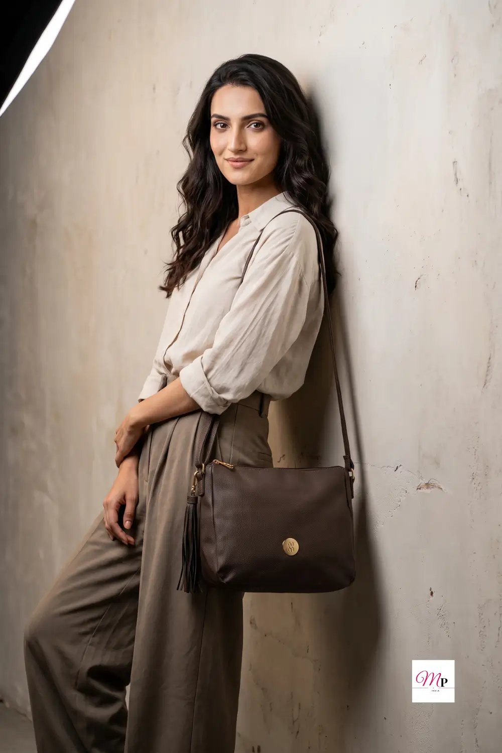 Woman wearing Baggit brown textured bag crossbody with neutral beige outfit — everyday office style for Indian women, shaadi ke liye bhi perfect