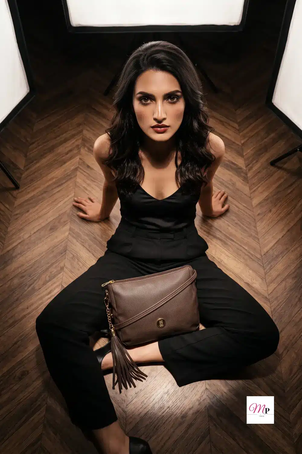 Editorial portrait with Baggit structured sling bag styled with all-black outfit — studio fashion photography for women in India