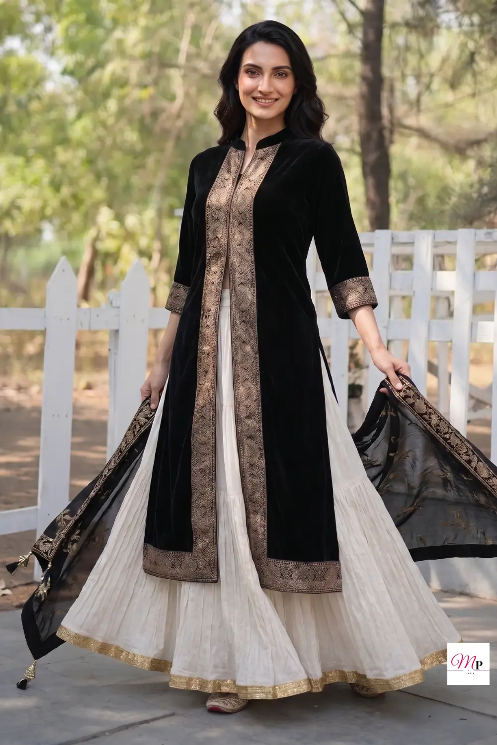 Biba black velvet anarkali opened to reveal cream lehenga layers and gold border detailing