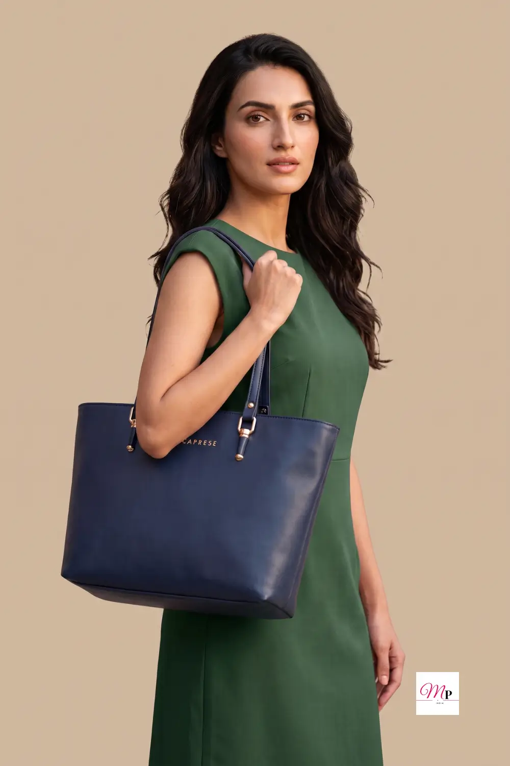 Woman in emerald dress holding Caprese navy tote bag as everyday office accessory