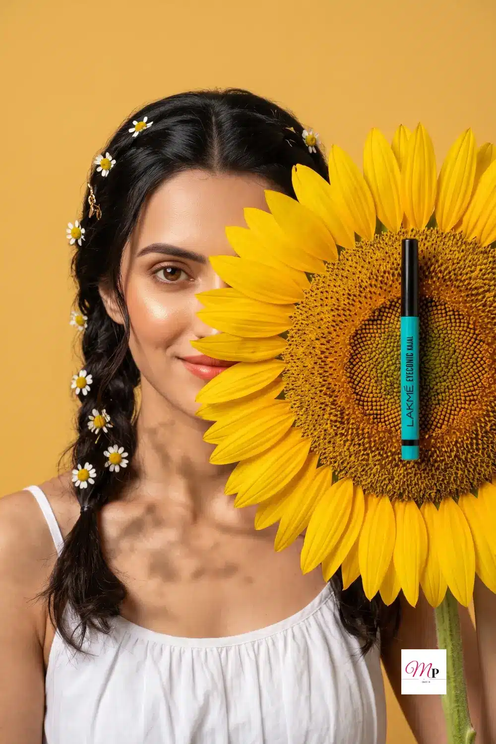 Lakme Eyeconic Kajal held against a bright sunflower with model styling | लैक्मे काजल