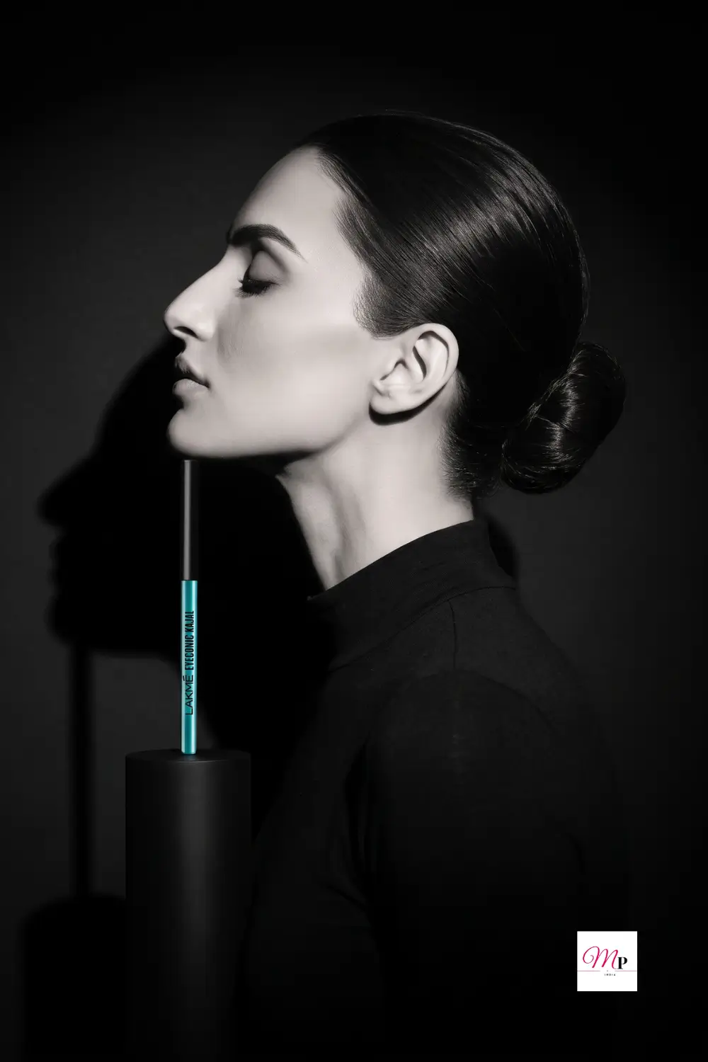 Artistic black and white portrait with Lakme Eyeconic Kajal on display pedestal