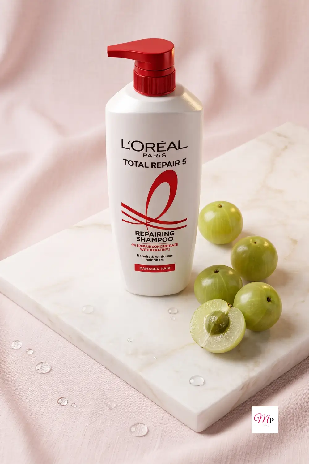 L'Oreal Total Repair 5 repairing shampoo with fresh green apples on textured pink background, hair strengthening shampoo