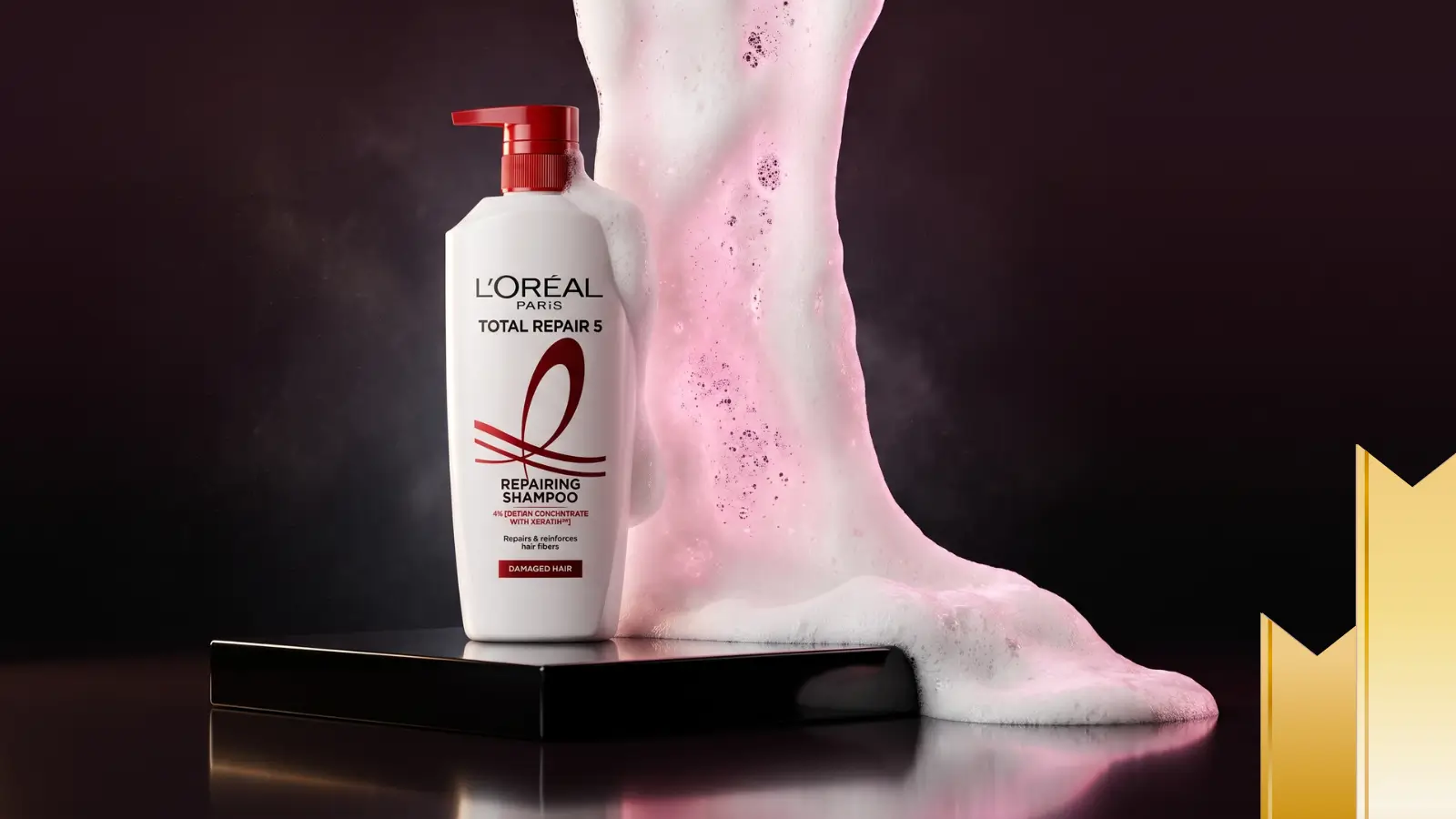 L'Oreal Paris Total Repair 5 repairing shampoo with keratin XS on dramatic pink fabric backdrop, loreal total repair 5 keratin shampoo