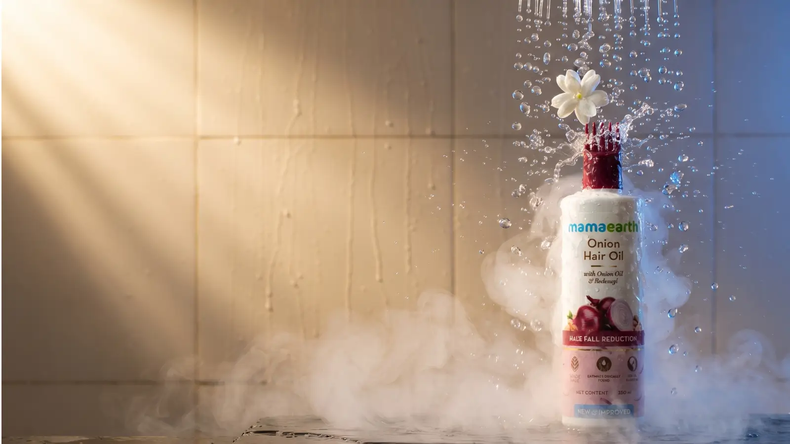 Mamaearth Onion Hair Oil with Redensyl water splash product photography