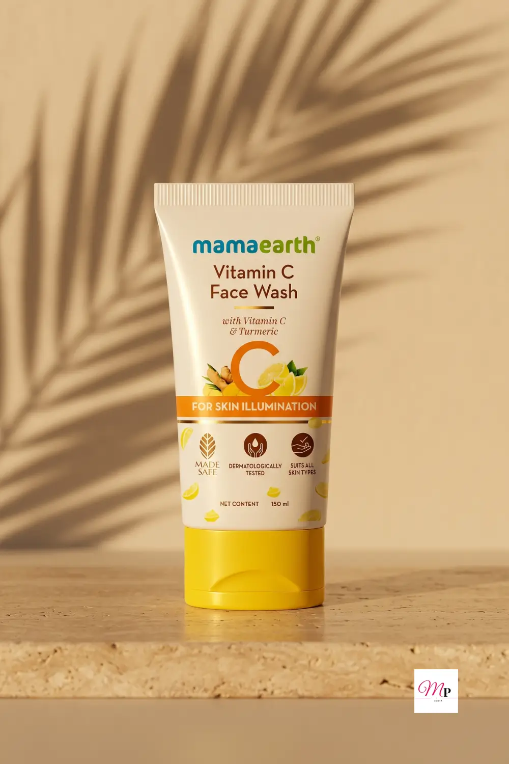 Mamaearth Vitamin C Face Wash tube on warm beige travertine surface with palm leaf shadows and natural sunlight