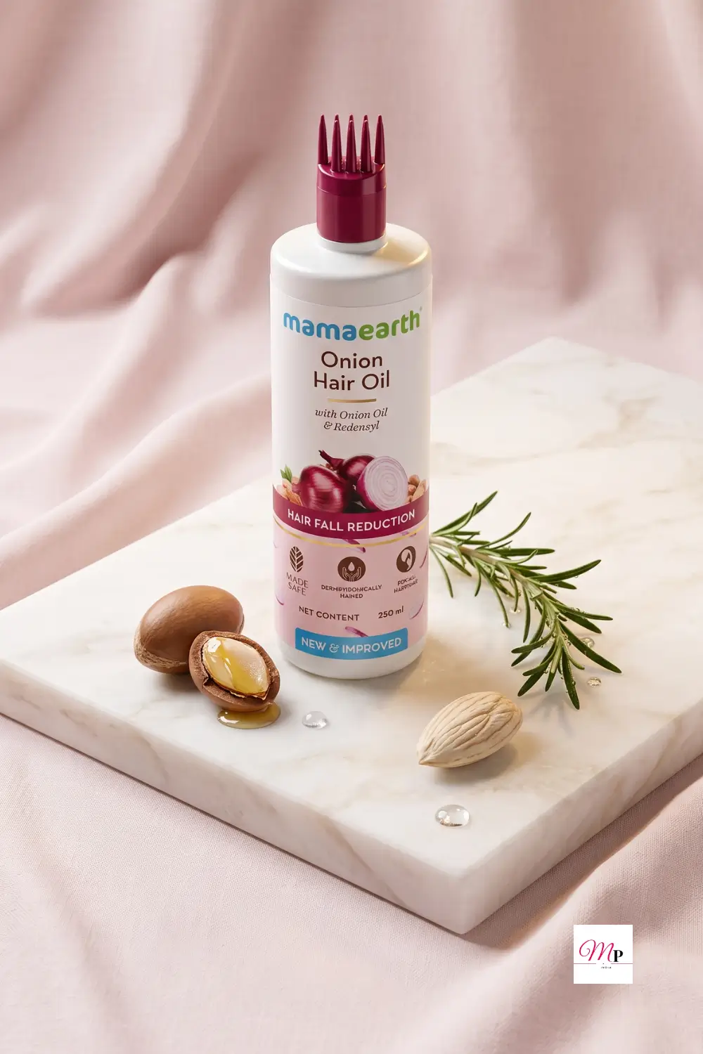 Mamaearth Onion Hair Oil with argan nuts and rosemary ingredients display