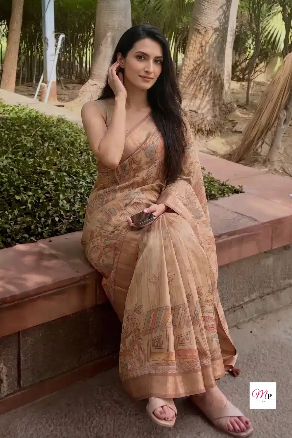 shaadi ke liye perfect silk blend saree with warli print styled casually on stone bench in park