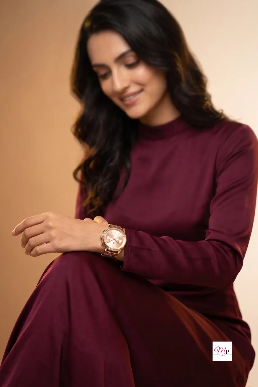 Tommy Hilfiger gold watch women myntra — lifestyle shot on wrist with burgundy dress and rose gold mesh band