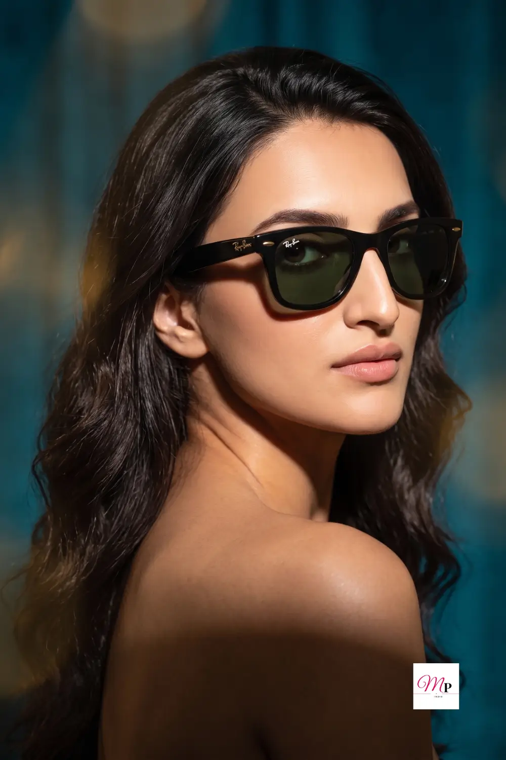 Dramatic teal studio portrait of woman wearing black square frame sunglasses — shaadi ke liye perfect statement eyewear