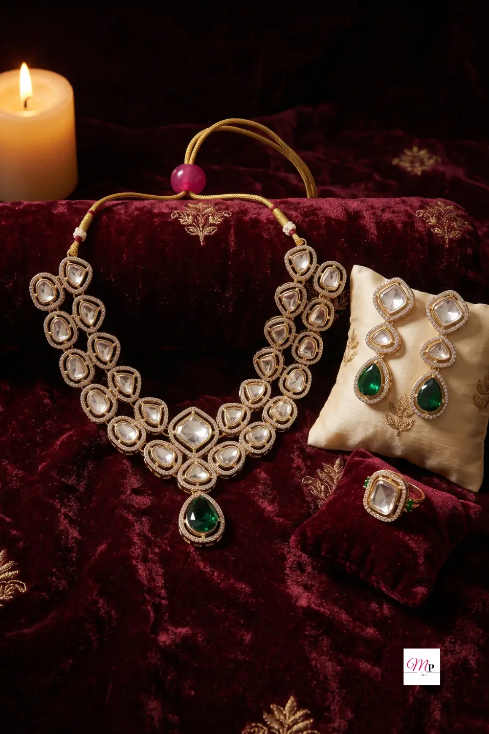 Austrian diamond studded jewellery set displayed on maroon velvet with candlelight and cream cushion