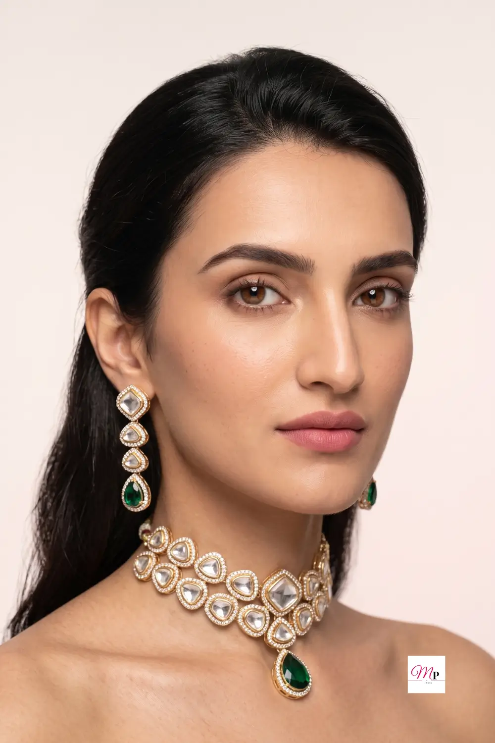 Close-up portrait of woman wearing festive gold plated Austrian diamond necklace and matching earrings