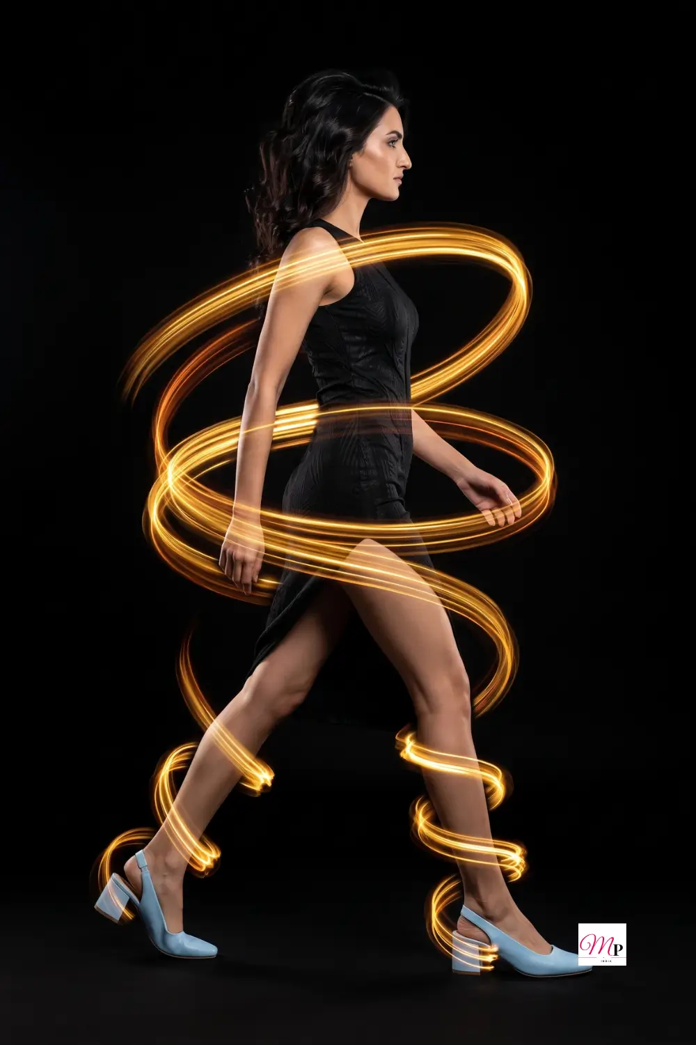 Blue block heels mid stride wrapped in gold light trails editorial