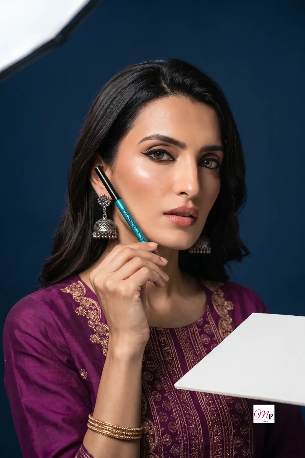 Lakme Eyeconic kajal styled with magenta embroidered kurta set and oxidised jhumkas for Ganesh Chaturthi festive look — complete festive makeup for women India