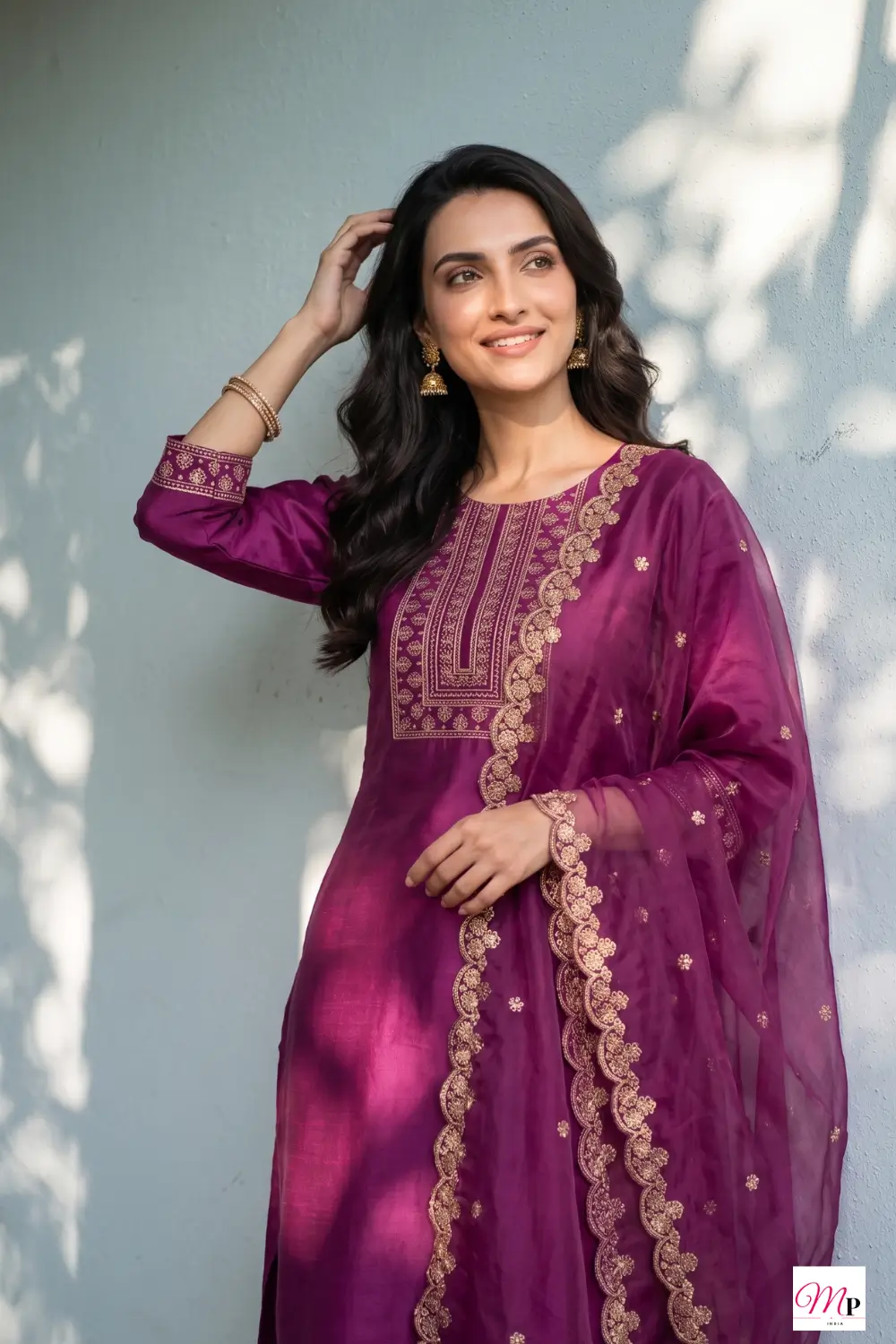 Woman wearing Anouk magenta embroidered kurta set with gold scalloped dupatta for Ganesh Chaturthi — festive kurta set for women India