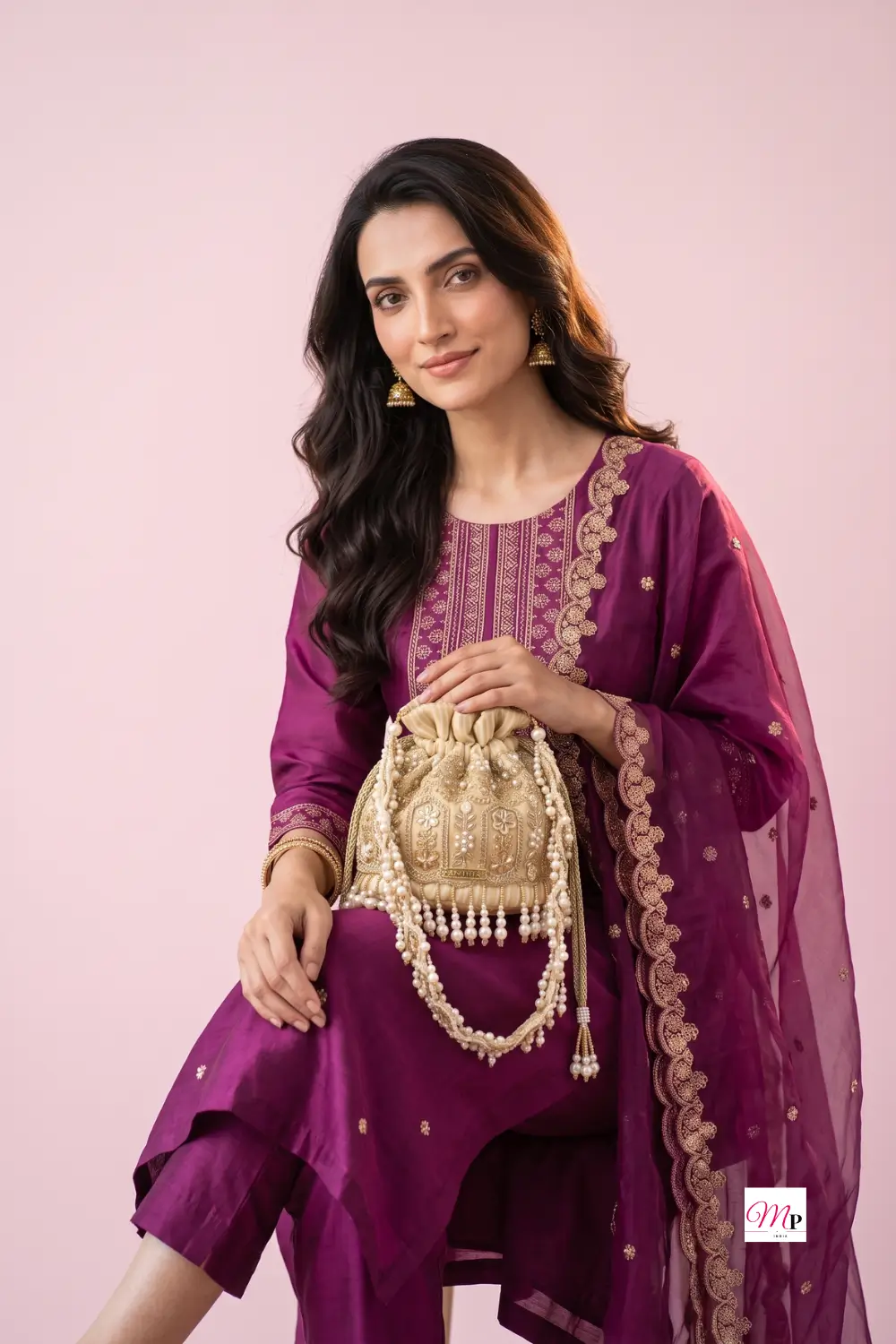 Pearl embellished potli bag paired with magenta embroidered kurta set for festive occasion styling — Ganesh Chaturthi potli bag for women India
