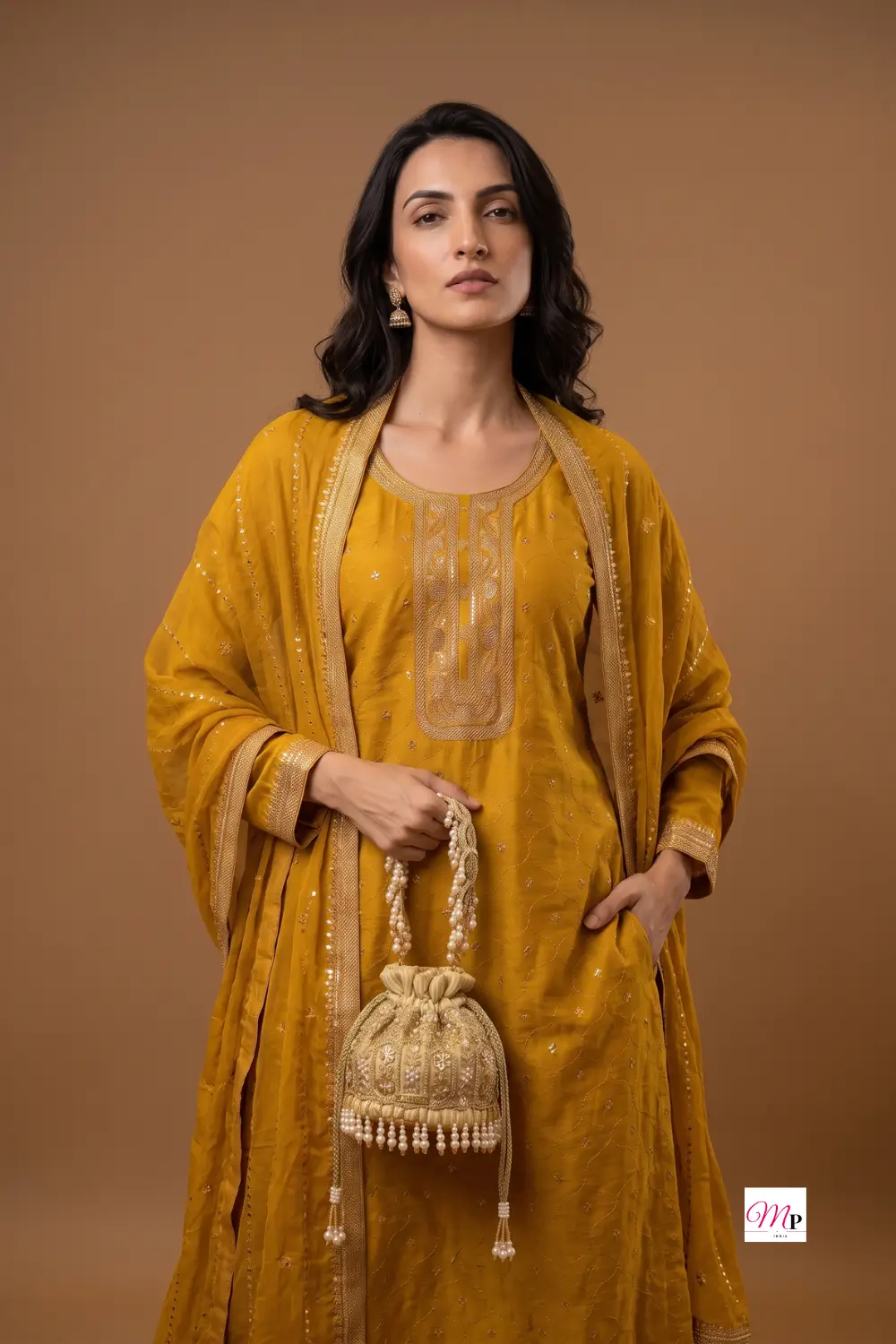 Gold embellished potli bag styled with yellow sequined kurta set for Ganesh Chaturthi pooja look — festive accessories for women India