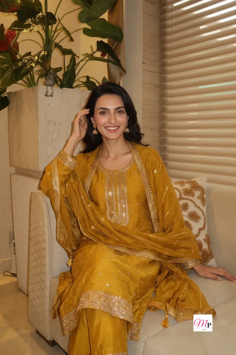 Woman wearing Libas yellow sequined kurta set with gold border dupatta for Ganesh Chaturthi festive styling — Ganesh Chaturthi outfit for women India