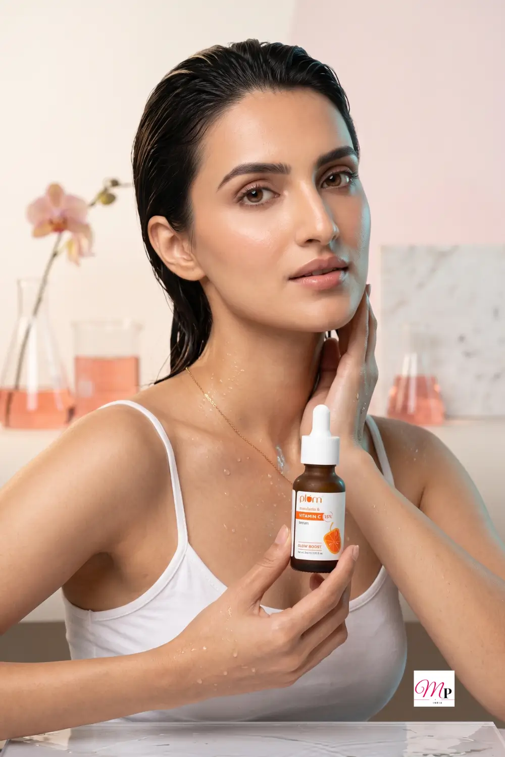Dewy wet-look skin with water droplets after applying lightweight Plum Vitamin C serum — chamakta dewy glow for humid Indian weather