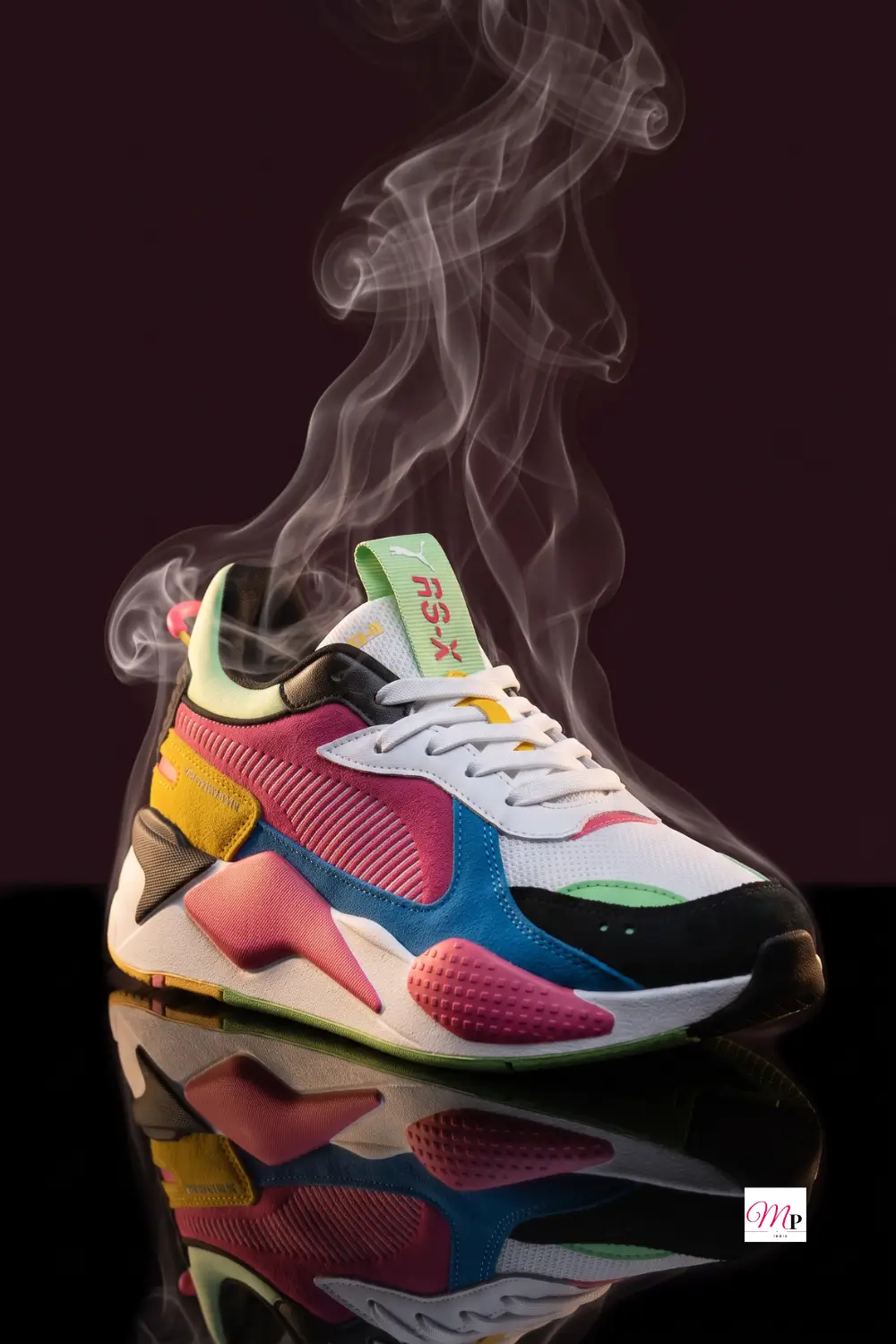 chunky multicolour sneaker still life with smoke on reflective black surface