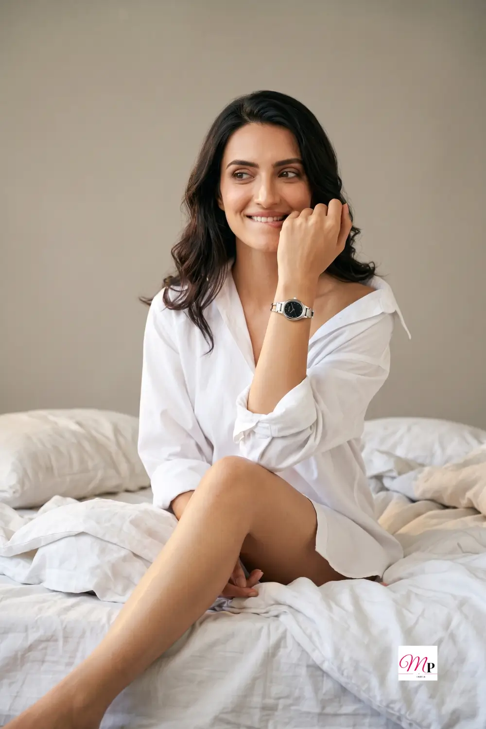 Smiling woman in white shirt wearing a Sonata analog black dial watch on her wrist in soft morning light
