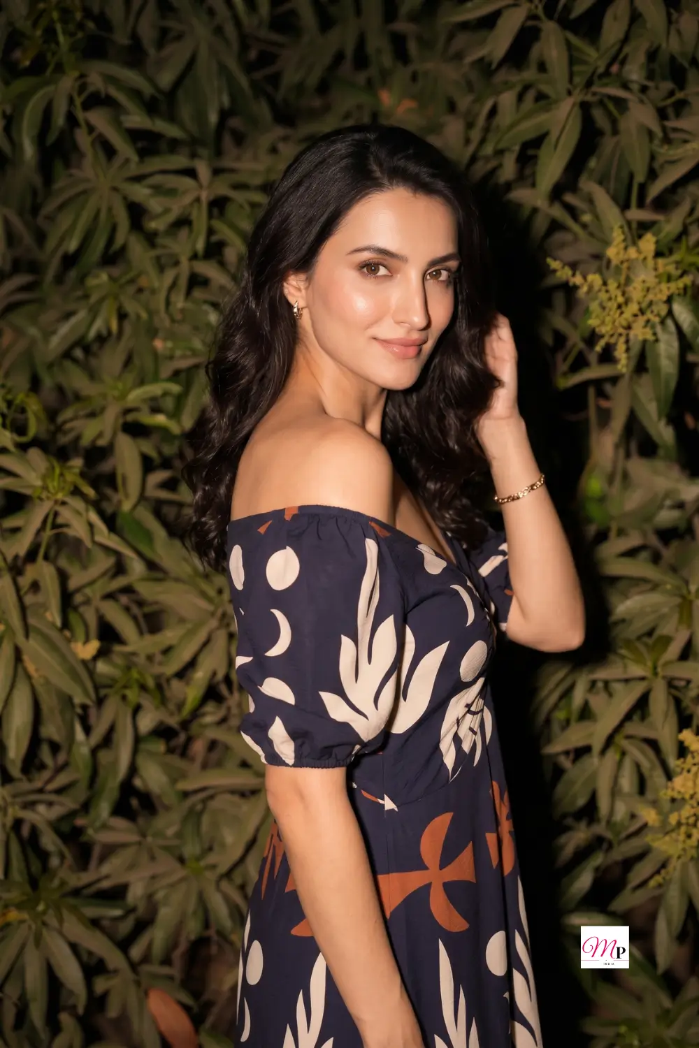 Back view of off-shoulder printed midi dress showing elastic neckline in a night garden — shaam ke dinner ke liye