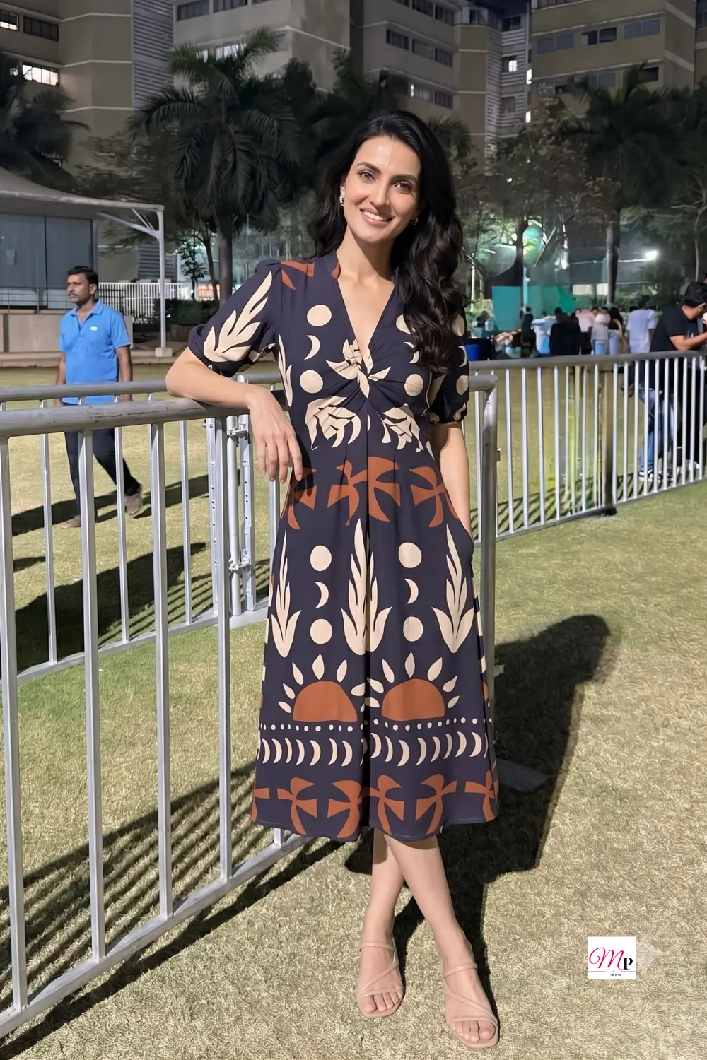 Printed crepe midi dress worn on-shoulder with flat nude sandals for a daytime outing